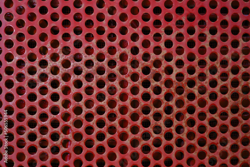 red metal grid circle holes painted iron industrial texture background photo