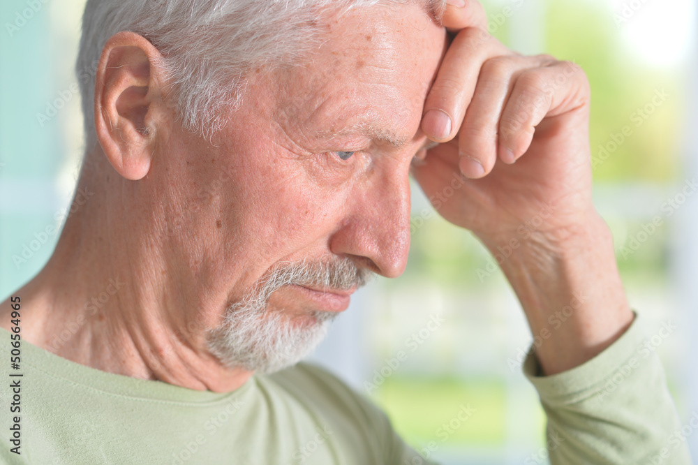 Obraz premium Portrait of sad sick senior man at home