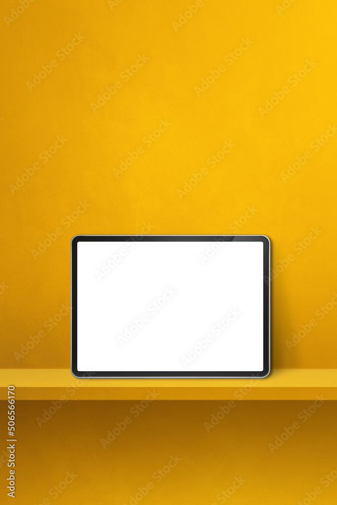Digital tablet pc on yellow wall shelf. Vertical background banner Digital tablet pc on yellow wall shelf. Vertical background banner