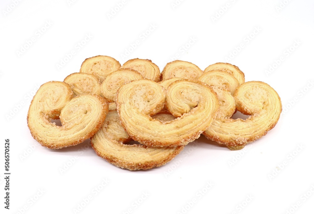 Palmier or Palmeras, a french puff pastry in palm leaf shape, on white background.