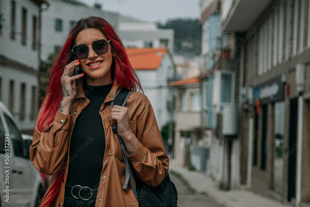 red hair tourist woman around the city with phone and backpack red hair tourist woman around the city with phone and backpack