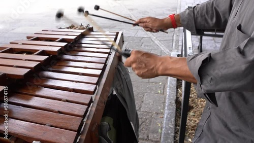 Hands of anonymous street musician playing xylophone with ball mallets in Guadalajara city, Mexico