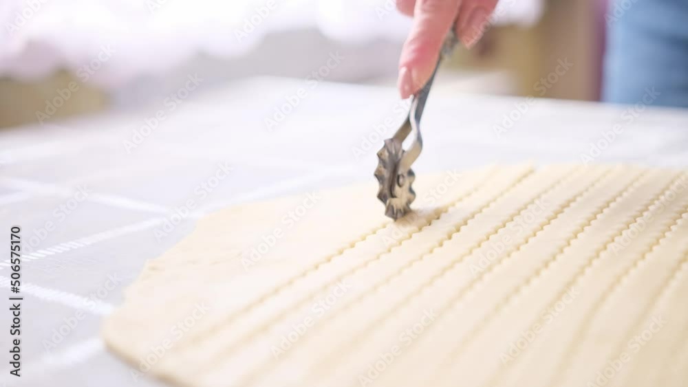 Apple pie cake preparation series - woman slicing rolled dough with rolling knife Apple pie cake preparation series - woman slicing rolled dough with rolling knife