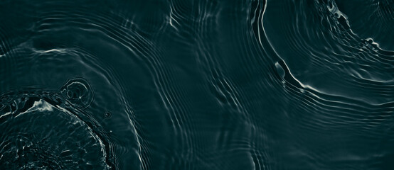 Black transparent clear calm water surface texture with ripples, splashes. Abstract nature banner background. Dark grey water waves. Copy space, top view. Cosmetic moisturizer micellar toner emulsion