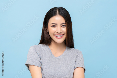 Принти на полотні Portrait of pretty southeast Asian girl smiling in light blue color isolated stu