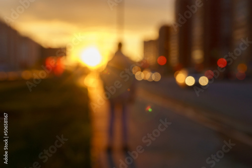 Fototapet Out of focus sunset background of the city, embankment street, cars and people o