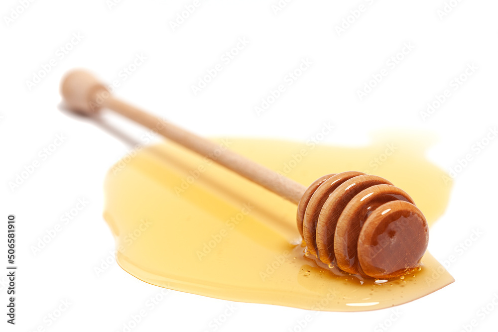 Wooden dipper with honey isolated on a white background. Golden organic floral honey natural. Wooden dipper with honey isolated on a white background. Golden organic floral honey natural.
