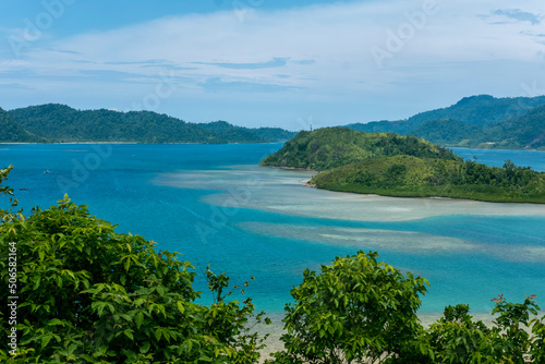 The view of island cover with turquoise sea and blue sky background at Mandeh, South Pesisir, West Sumatera photo