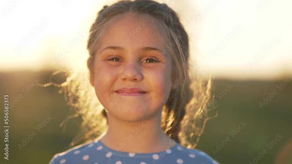 Happy girl in sun. Girl face in park hair in the wind. Dream girl. Happy face of a child in sun. The child smiles at the camera. Girl's dream. Face close-up. Happy child in the park. Beautiful face Happy girl in sun. Girl face in park hair in the wind. Dream girl. Happy face of a child in sun. The child smiles at the camera. Girl's dream. Face close-up. Happy child in the park. Beautiful face