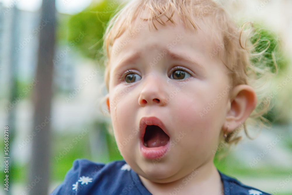 Baby crying in the park. Selective focus. Baby crying in the park. Selective focus.