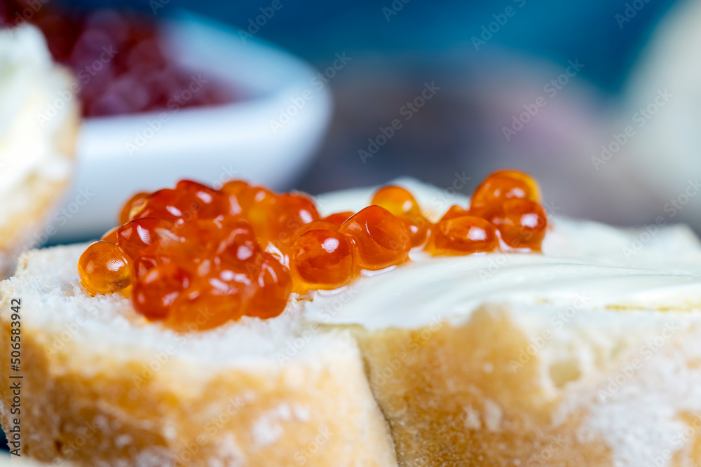 red salmon or trout caviar with white baguette and butter red salmon or trout caviar with white baguette and butter