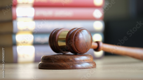 Judicial gavel and books in courtroom closeup photo