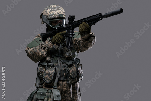 Fotografie, Obraz Photo of professional servicewoman aiming rifle dressed in camouflage uniform