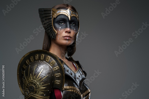 Wallpaper Mural Portrait of attractive woman warrior with painted face dressed in dark steel armor