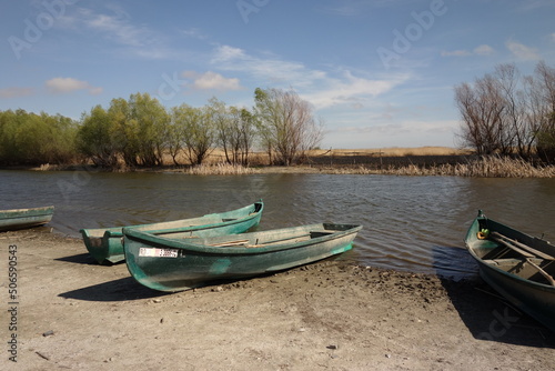 landscape in danube delta, tulcea, romania, in parches, with traditional wooden boats