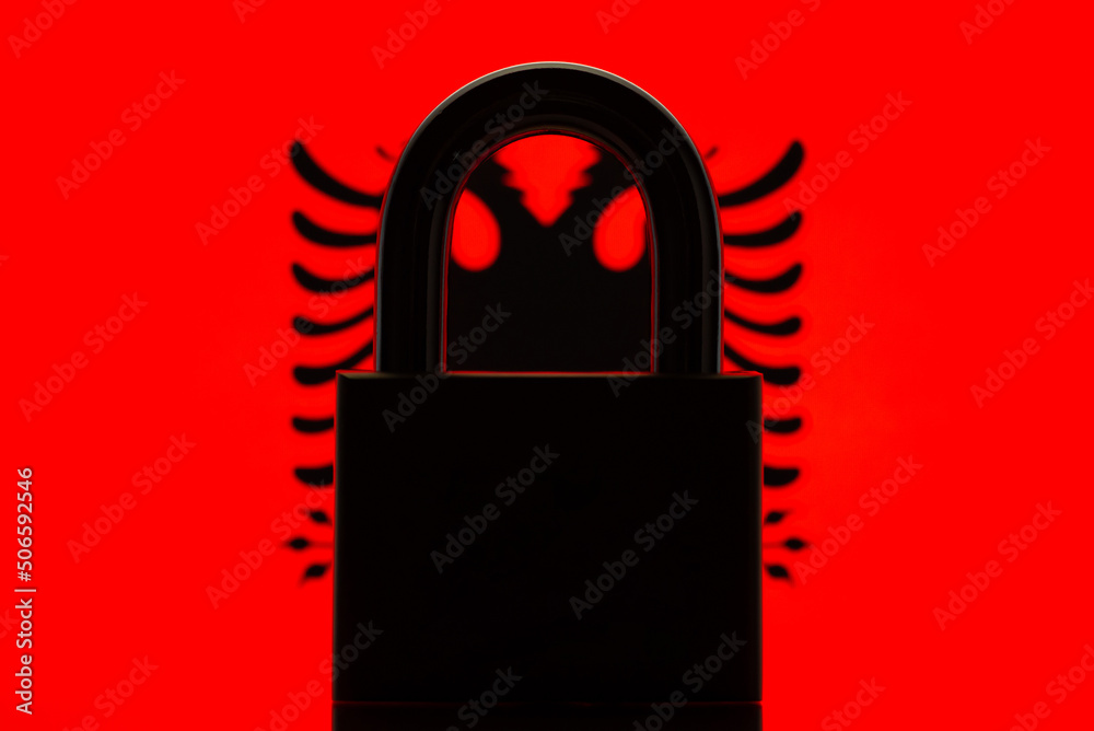 Silhouette of lock on the background of flag of Albania. Concept of closed country, difficulties of entering country Silhouette of lock on the background of flag of Albania. Concept of closed country, difficulties of entering country