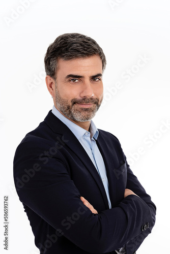 Businessman smiling with arms crossed on white background 