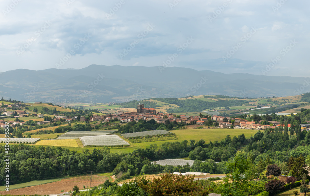 Landscape of the Monts du Lyonnais and the small village of Saint-Didier-sous-Riverie, and in the background the Massif Central, in Auvergne-Rhône-Alpes, France