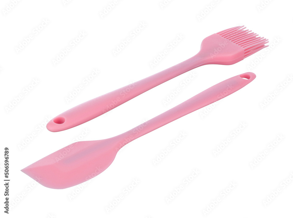 Kitchen spatula and brush made of soft pink heat-resistant silicone, small size, isolated on a white background. Modern kitchen tools. Kitchen spatula and brush made of soft pink heat-resistant silicone, small size, isolated on a white background. Modern kitchen tools.