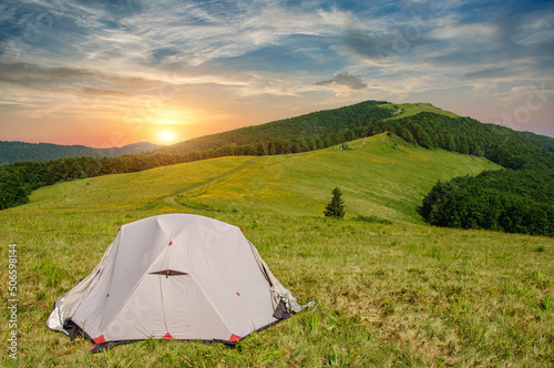 tent stand on a mountain range in the Carpathians at sunset
