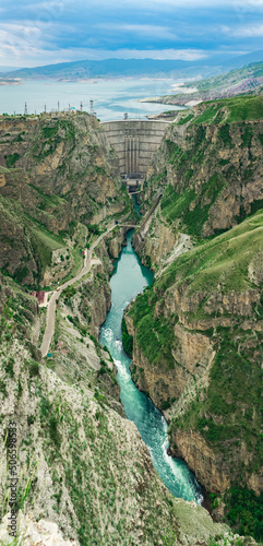 view of the arch dam with a spillway in the canyon