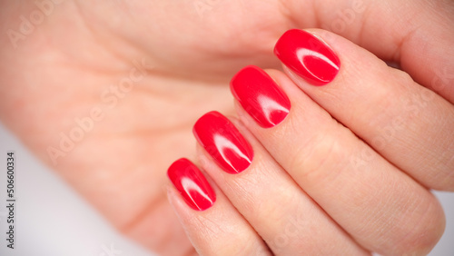 Female hands with beautiful bright red nails closeup