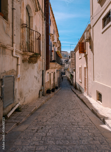 Alley in the historic center of Scicli with man walking