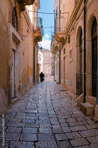 Scicli alley with elderly lady walking