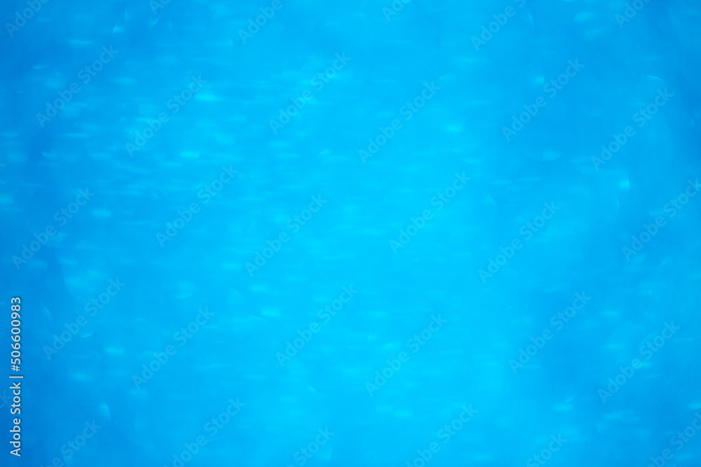 Background light bokeh texture. Beautiful festive Christmas background for the design of congratulations. Nacreous sparkling blue texture. Background light bokeh texture. Beautiful festive Christmas background for the design of congratulations. Nacreous sparkling blue texture.