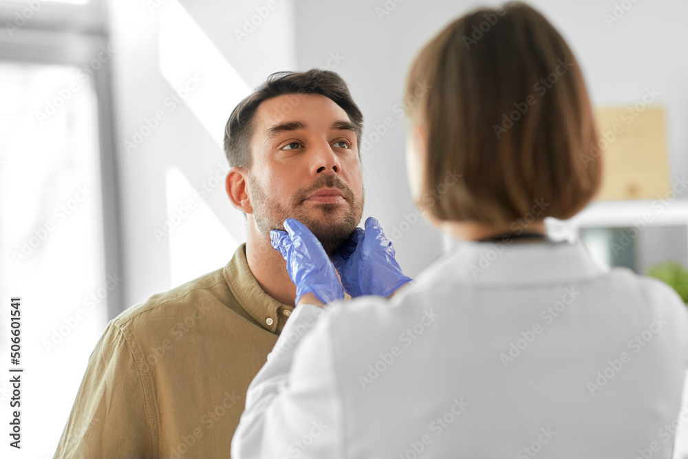 medicine, healthcare and people concept - female doctor checking lymph nodes of man patient at hospital medicine, healthcare and people concept - female doctor checking lymph nodes of man patient at hospital