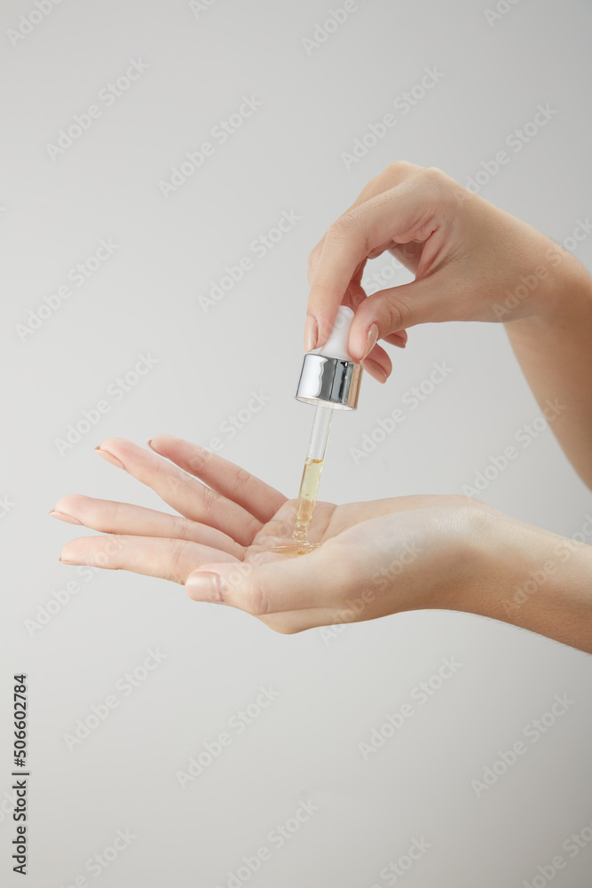 Front view of hand model using cosmetic in white background Front view of hand model using cosmetic in white background