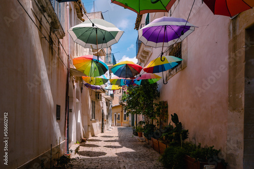 Characteristic alleyway in the historic centre of Scicli with colourful umbrellas hanging © Jan Cattaneo