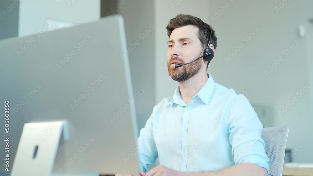 Corporate operator working in customer support service on helpline telesales. Focused man representative call center agent in wireless headset helping client with complaints using computer in office
