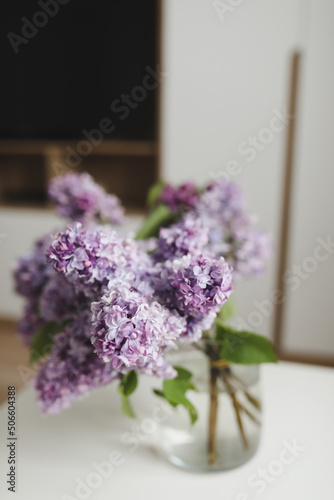 Home interior decor, bouquet of lilacs in a vase on table