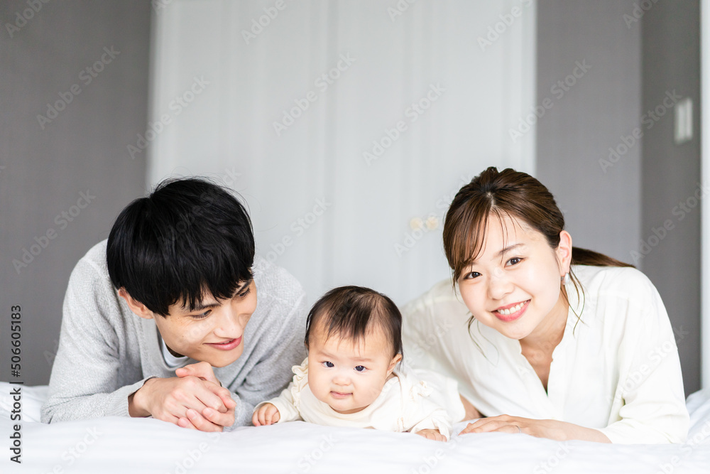 赤ちゃんと一緒に寝転ぶファミリー 赤ちゃんと一緒に寝転ぶファミリー