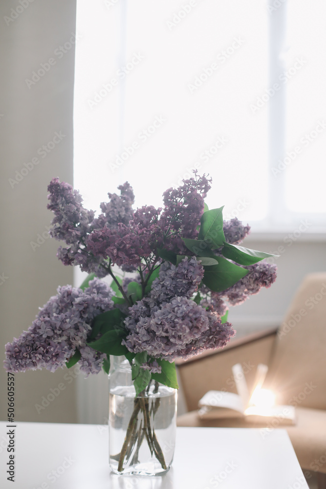 Home interior decor, bouquet of lilacs in a vase on table Home interior decor, bouquet of lilacs in a vase on table