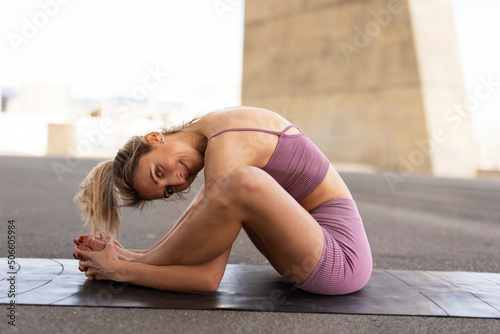 Young woman doing stretching exercise after running outside. Healthy lifestyle
