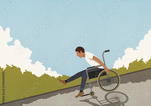 Happy, exhilarated man speeding downhill in wheelchair
 photo