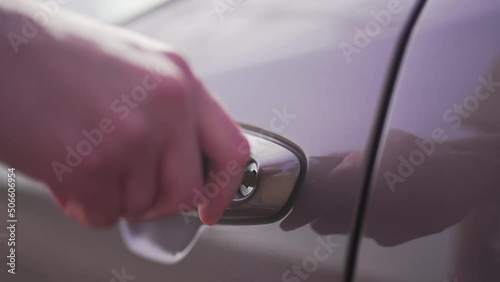 Person opens or closes the car door with a key. Mechanical open transport. Close-up 4K 10 BIT