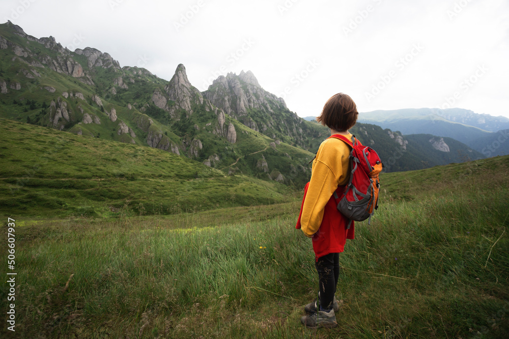 tourist girl standing on the trail