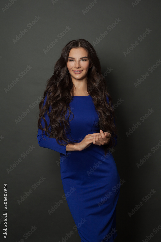 Portrait of young nice brunette model with professional make up, trendy wavy hairdo and perfect skin posing in classic dress Portrait of young nice brunette model with professional make up, trendy wavy hairdo and perfect skin posing in classic dress
