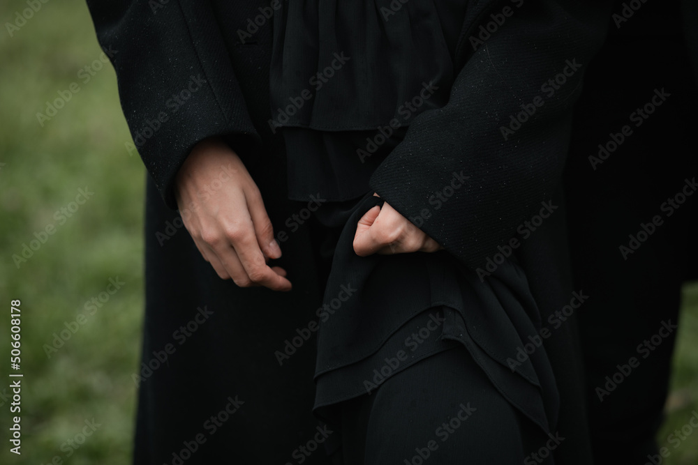 A man in a black coat, hands close up. Sad autumn mood. A man in a black coat, hands close up. Sad autumn mood.
