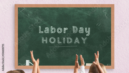 Labor day holiday writing on green chalkboard, school holidays days, students raising hands in front of the chalk board with wooden frame, school and classroom concept, preparation for Labor day