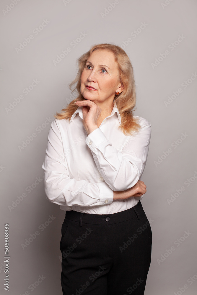 Middle age woman wearing white shirt thinking Middle age woman wearing white shirt thinking