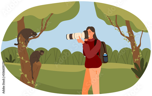 Photojournalist with camera takes pictures of animals in their natural habitat. Photographer biologist photographing monkeys, chimpanzee on tree. Woman traveler naturalist in forest or jungle