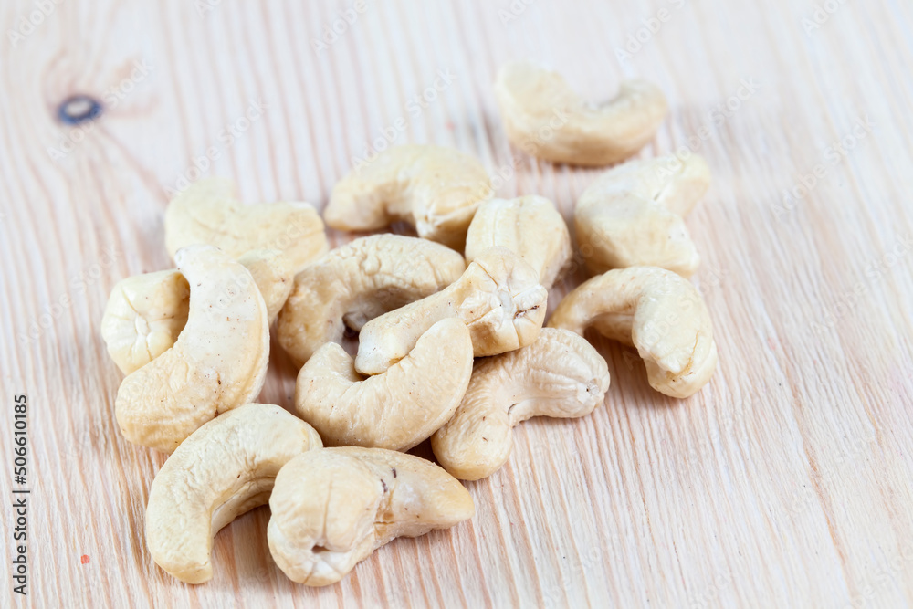 cashew nuts lying on a white board cashew nuts lying on a white board