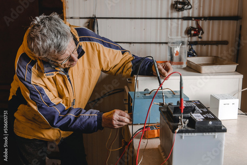 Mechanic doing service on electric car battery