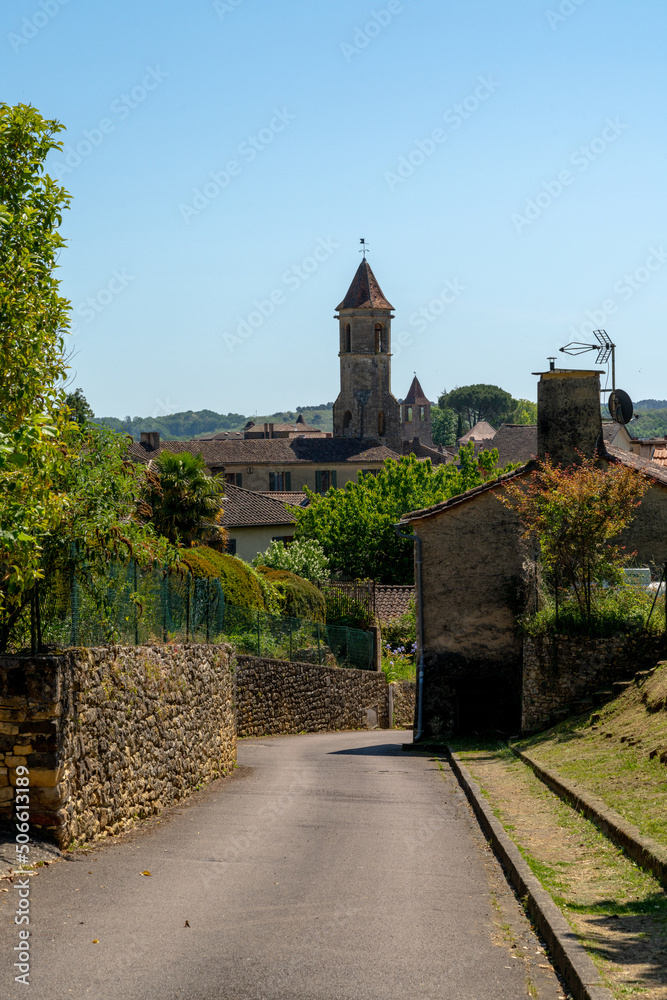 road leading into the idyllic town of Belves with a view of the Our Lady of Capelou Church