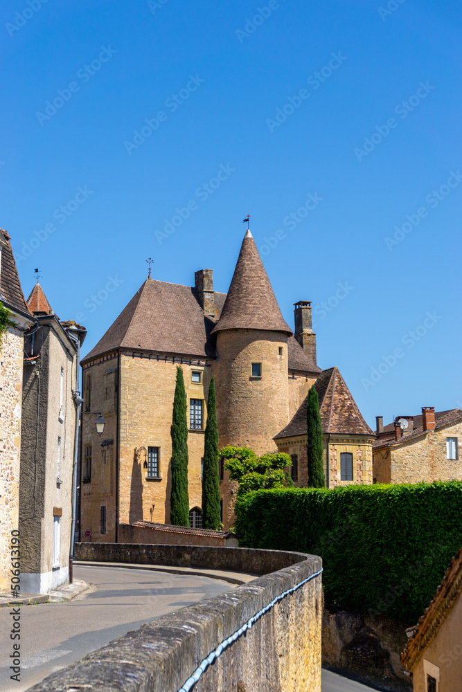 Obraz premium the Rue des Penitents leads to the city center of Belves with its historic brownstoen buildings