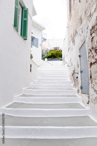Narrow medieval street with white stone steps in old mediterranean town © altana_studio